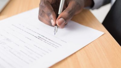 Man signing permanent employment contract contract