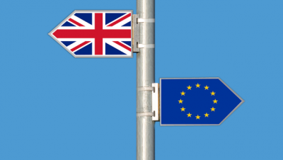 EU flag and UK flag on a flag pole representing Brexit